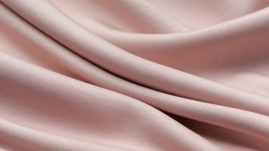 Zarif kıvrımlı yumuşak pembe kumaş dokusu, minimal kadınsı tasarım ve markalaşma için pastel tekstil arka planı