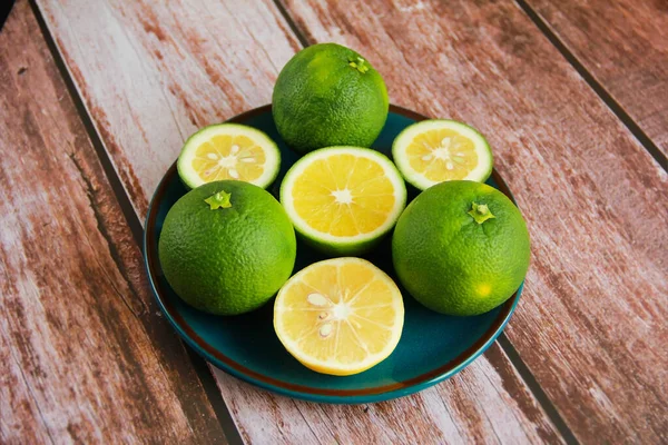 green lemon and round yellow lemon slices