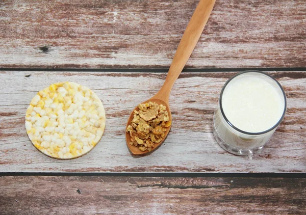 kefir in a glass and muesli in a spoon for a diet