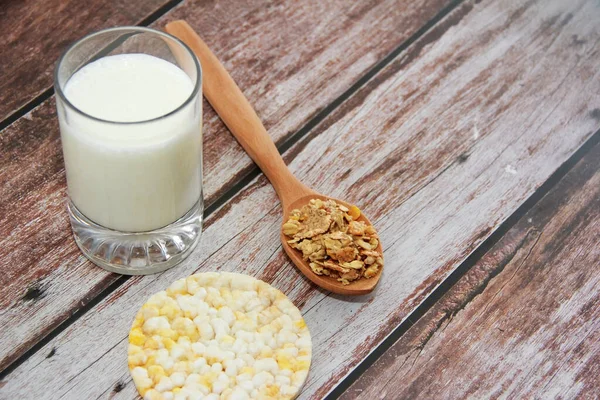 kefir in a glass and muesli in a spoon for a diet