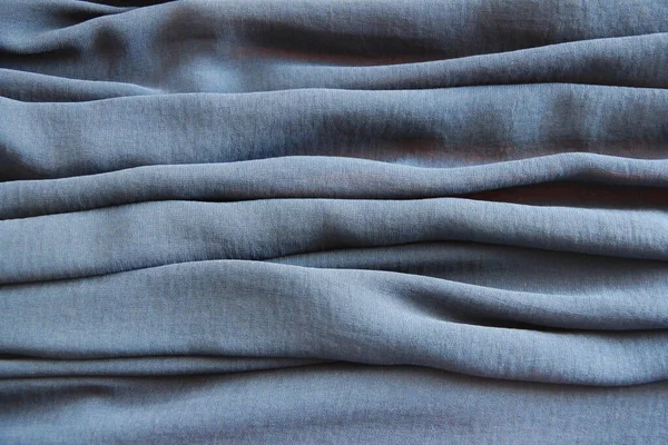 blue synthetic fabric with pleats