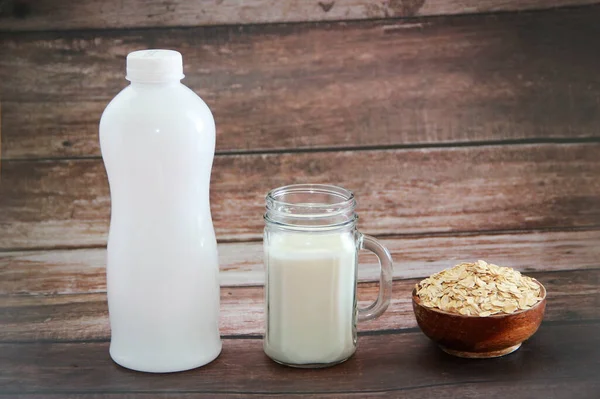 white milk kefir in a glass mug and dry dietary oat flakes