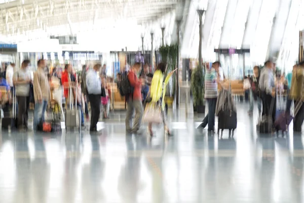 People silhouettes in motion blur, airport interior Stock Image