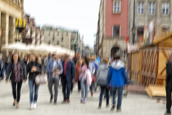 Blurred pedestrian in the city, zoom effect, motion blur