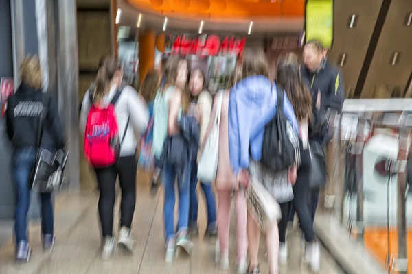 Crowd of people rushing through corridor, zoom effect, motion bl