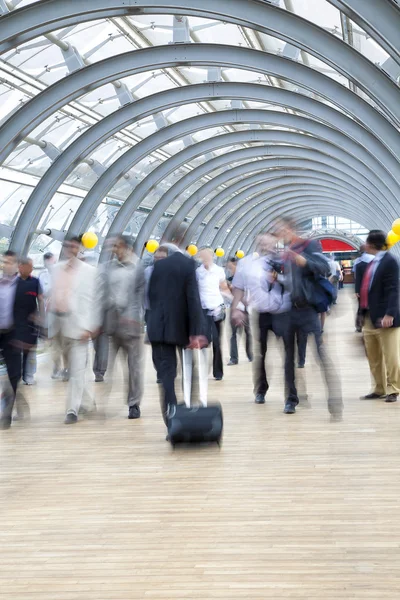 Commuters rushing in corridor, motion blur — Stock Photo, Image