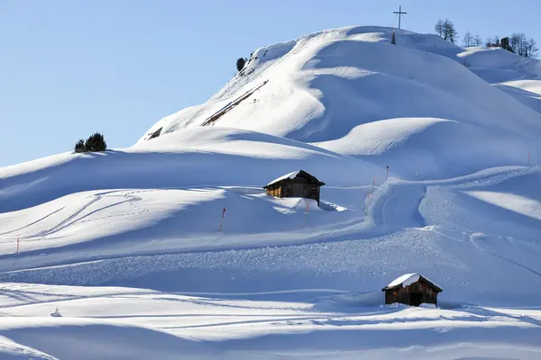 A mountain hut in winterly alpine scenery Royalty Free Stock Images