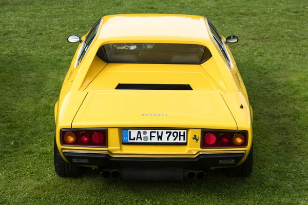 Munich, Germany - September 19, 2015: A rear view of a yellow 1975 Ferrari Dino 308 GT4 classic sports car parked on green grass. — Stock Photo, Image