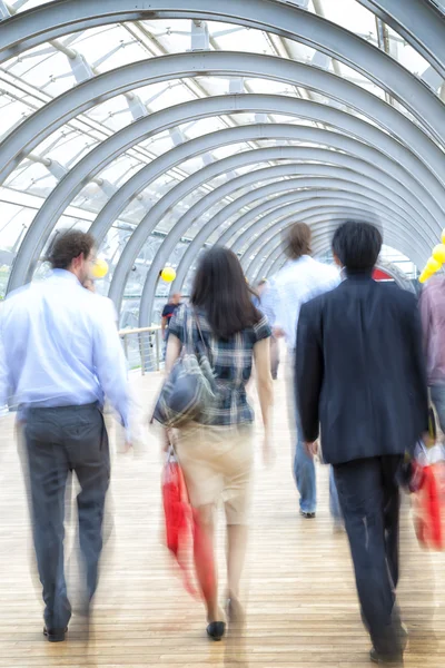 Motion blurred people in the office building — Stock Photo, Image