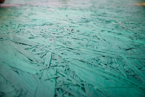 Abstract turquoise background with wooden chips slab