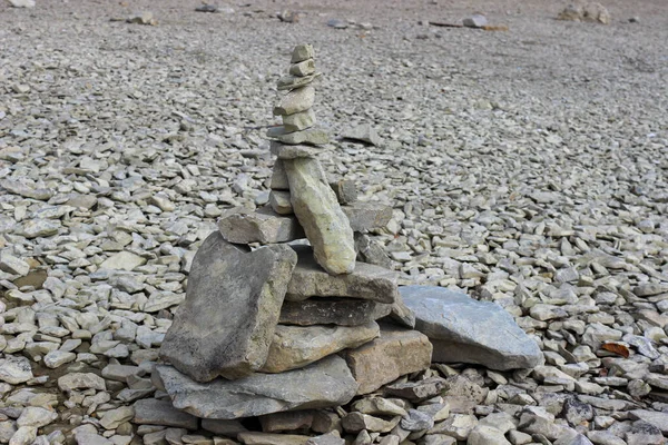 Rock balancing (or stone balancing) figure on lake shore