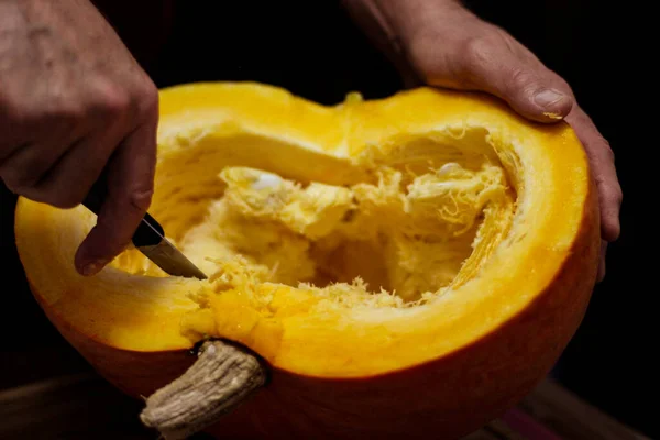 Ein Mann Schneidet Halloween Einen Reifen Kürbis Mit Einem Messer — Stockfoto