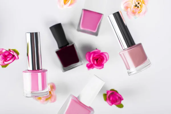 Beauty cosmetics makeup product flying. Womens makeup, nail Polish and flower fall in the air. Cosmetic makeup colorful set fly, levitation.