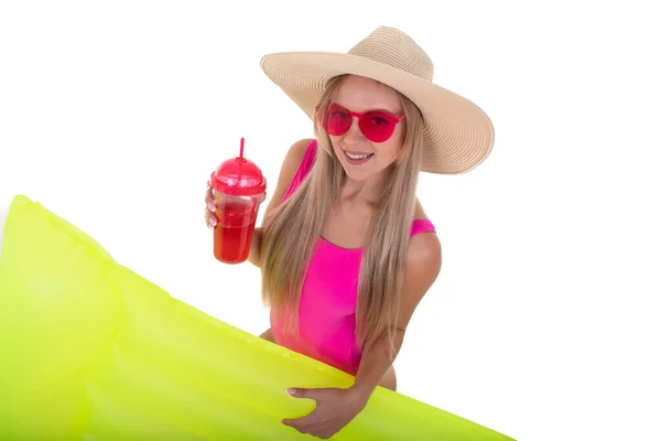 一位身穿粉色游泳衣 头戴粉色帽子的年轻女子拿着气垫 喝柠檬水 — 图库照片