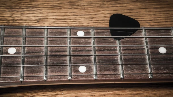 Guitar neck,strings and plectrum — Stock Photo, Image