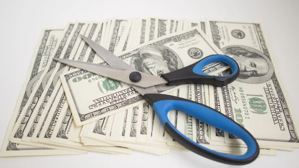 Dollar bills and large scissors — Stock Photo, Image