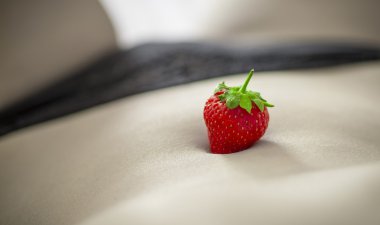 Bright juicy strawberry on a young woman's body clipart