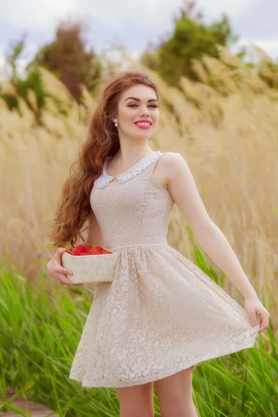 Girl with long hair in water in summer with strawberries — Stock Photo, Image