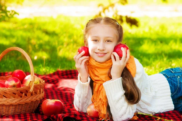 Colegiala con manzanas en otoño — Foto de Stock