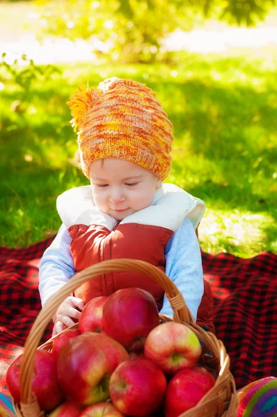 Little boy with apple in autumn — Stock Photo, Image