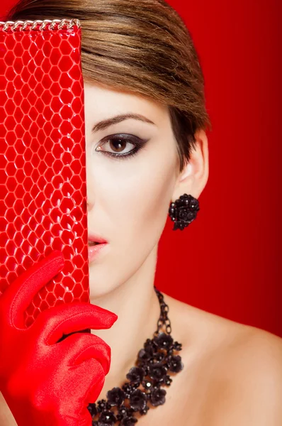 Beautiful girl with a red clutch bag — Stock Photo, Image