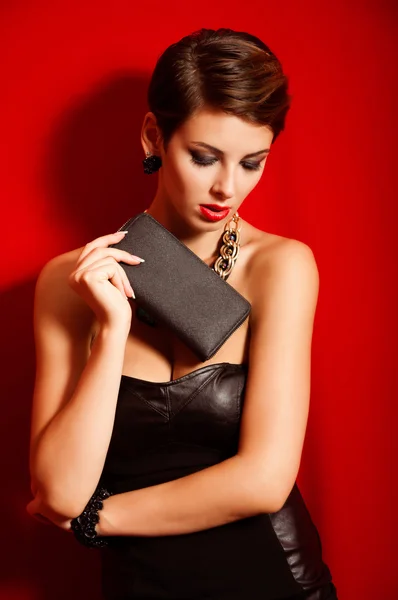 Beautiful girl with a  clutch bag — Stock Photo, Image