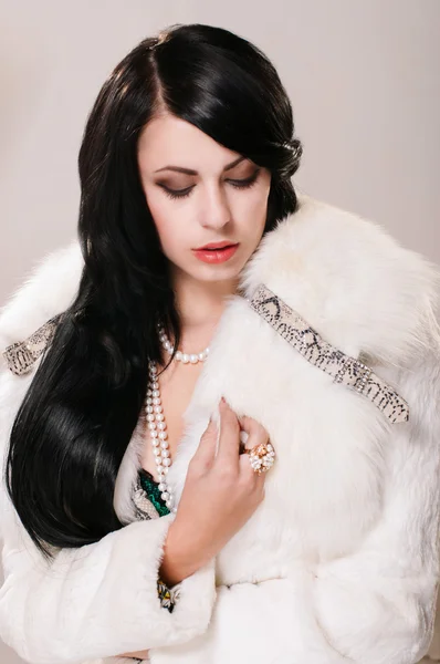 Beautiful girl in a white fur coat — Stock Photo, Image