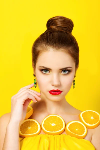 Beautiful girl with oranges and makeup — Stock Photo, Image