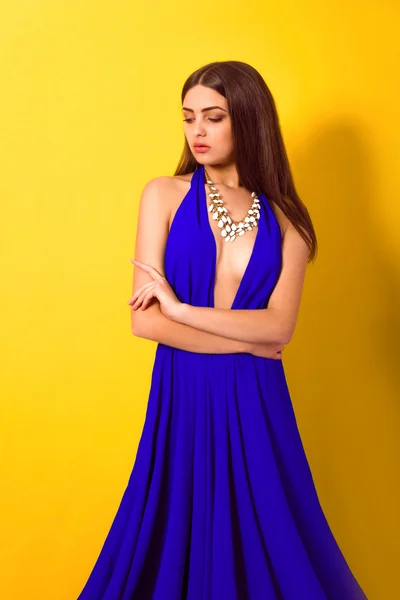 Beautiful young girl with long hair in a  blue dress — Stock Photo, Image