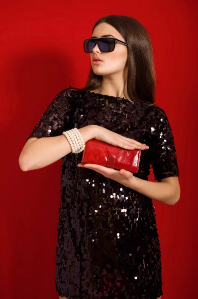 Beautiful young girl with long hair in a  black small  dress — Stock Photo, Image