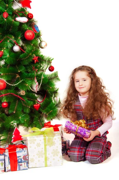 Petite fille près du sapin de Noël avec des cadeaux — Photo