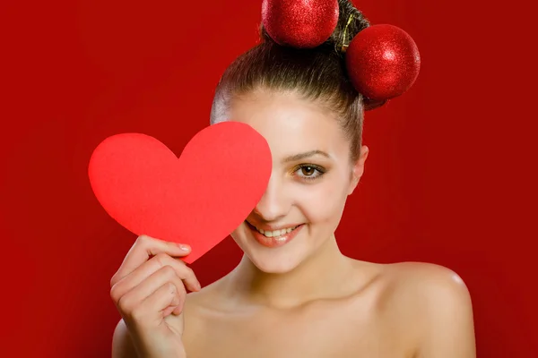 Young girl with a red heart toy in  hands — Stock Photo, Image