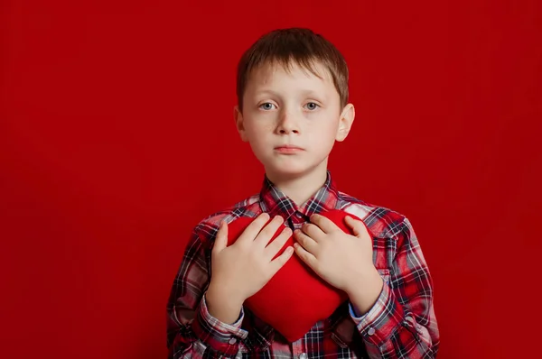 Little boy with a heart of toy — Stock Photo, Image