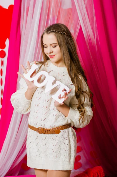 Beautiful girl  with the word love — Stock Photo, Image