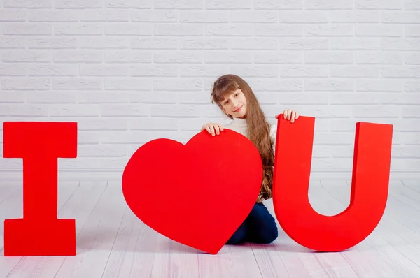 Little girl with a big  word I love you — Stock Photo, Image