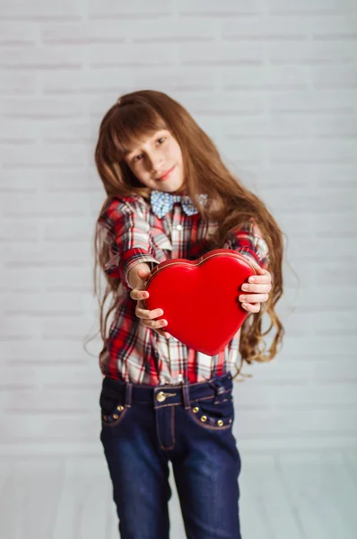 Little girl with a red box of chocolates — Stock Photo, Image