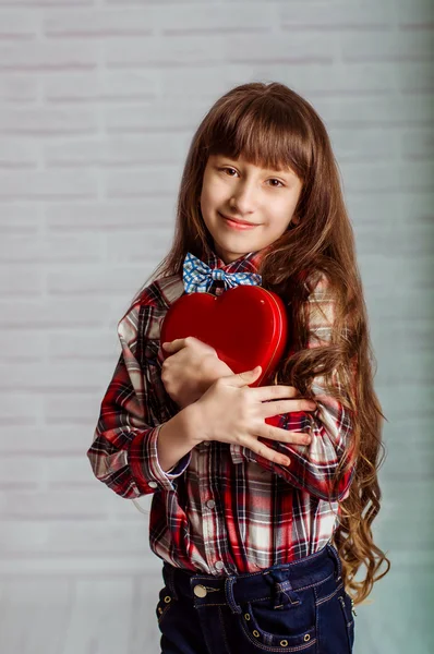 Маленькая девочка с красной коробкой конфет — стоковое фото