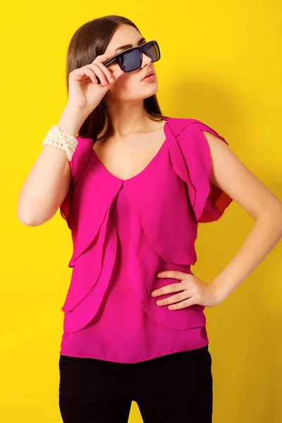 Beautiful young girl with long hair in a purple blouse — Stock Photo, Image