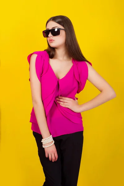 Beautiful young girl with long hair in a purple blouse — Stock Photo, Image