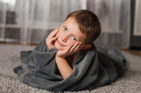 Little boy at home on the carpet — Stock Photo, Image