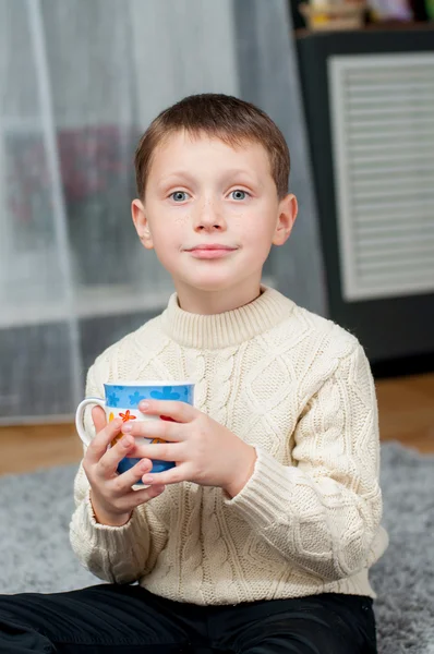 Little boy at home on the carpet — Stock Photo, Image