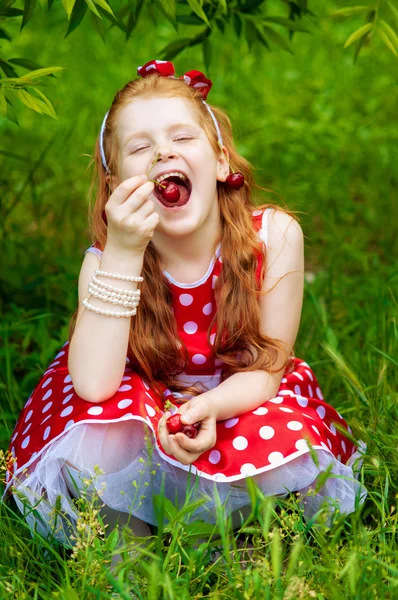 Girl in a  dress in cherry garden — Stock Photo, Image