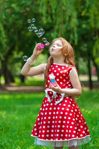 Beautiful dress girl with soap bubbles — Stock Photo, Image