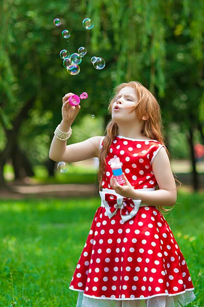 Beautiful dress girl with soap bubbles — Stock Photo, Image
