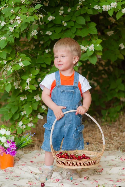 Little boy with a cherry in his hand — 图库照片