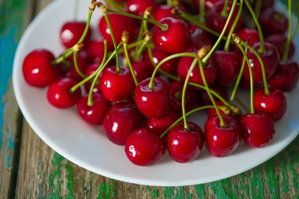 Cherry on  plate on the table — Stock Photo, Image
