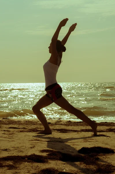 Fille est engagée dans le yoga sur la plage — Photo