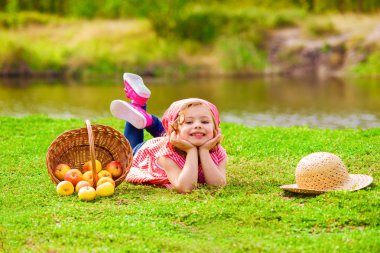Küçük kız kot pantolon ve gömlek bir nehir sonbaharda yakın: