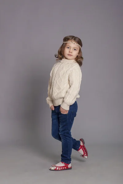 Little girl in white sweater and  jeans — Stock Photo, Image