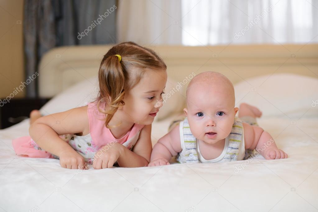 Children baby brother and sister in the bed